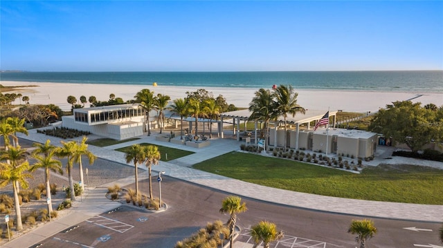 exterior space featuring a water view and a beach view