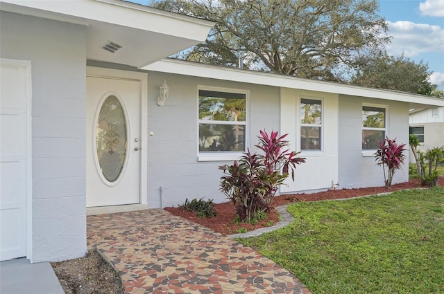 entrance to property with a yard