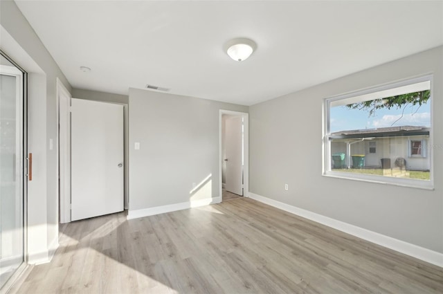 unfurnished bedroom with light wood-type flooring