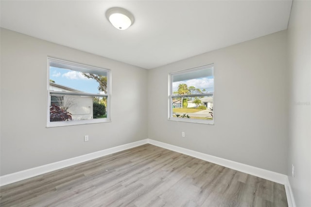 spare room with a healthy amount of sunlight and light wood-type flooring