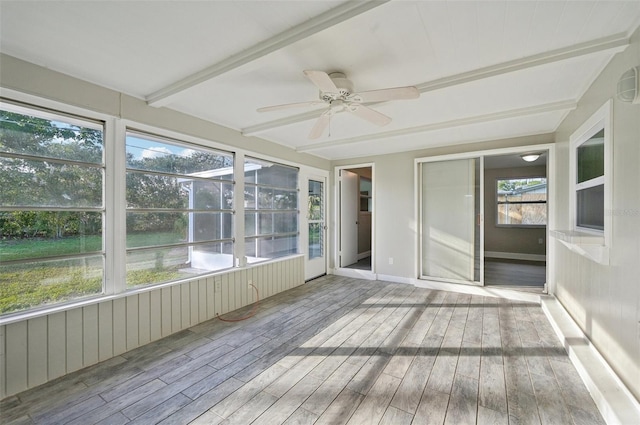 unfurnished sunroom with ceiling fan and beam ceiling