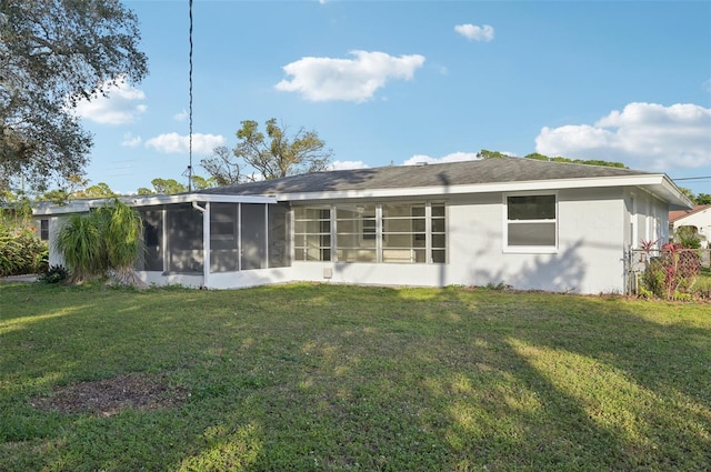 back of house with a lawn and a sunroom