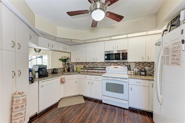 kitchen with light stone counters, white appliances, and white cabinets