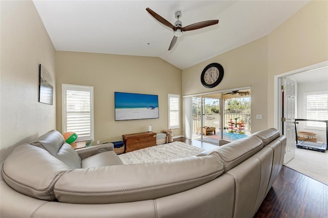 living room featuring lofted ceiling, dark wood-type flooring, and ceiling fan