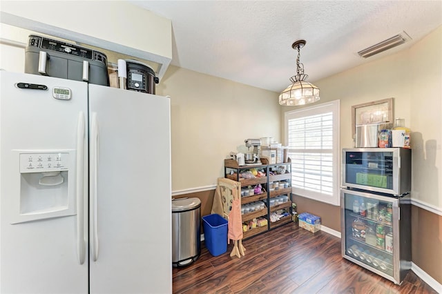 interior space with white fridge with ice dispenser, wine cooler, a textured ceiling, and dark hardwood / wood-style flooring