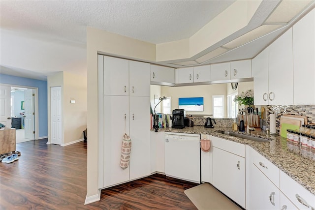 kitchen featuring sink, dark wood-type flooring, white cabinetry, white dishwasher, and light stone countertops