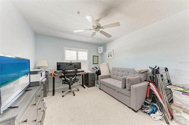 carpeted office with ceiling fan and a textured ceiling