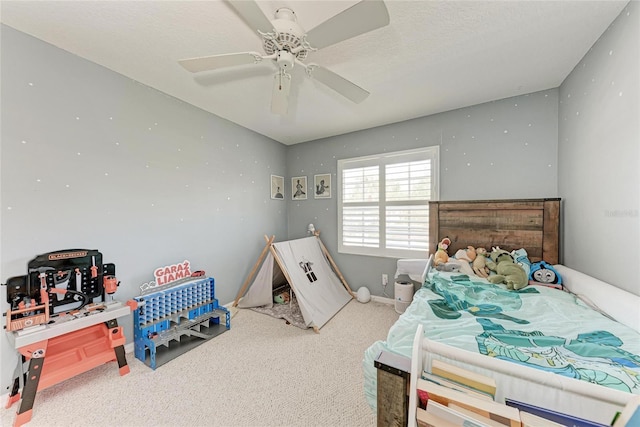 carpeted bedroom featuring a textured ceiling and ceiling fan