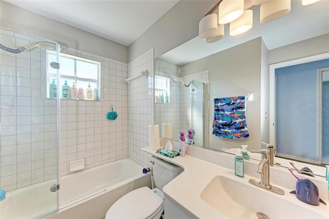 full bathroom with vanity, tiled shower / bath, and toilet