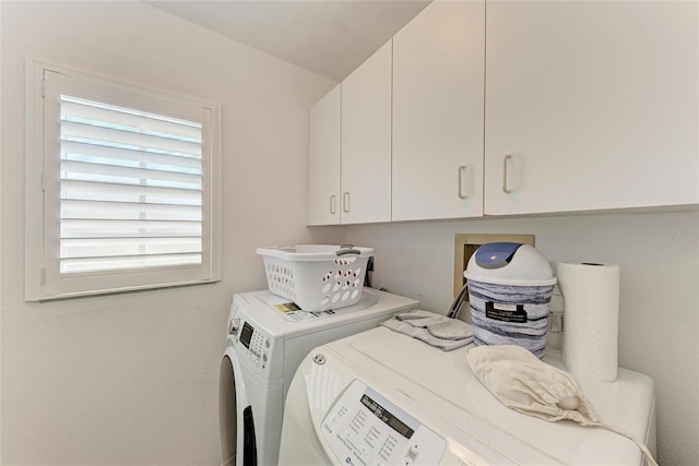 washroom with cabinets and independent washer and dryer