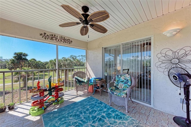 unfurnished sunroom featuring wooden ceiling and ceiling fan