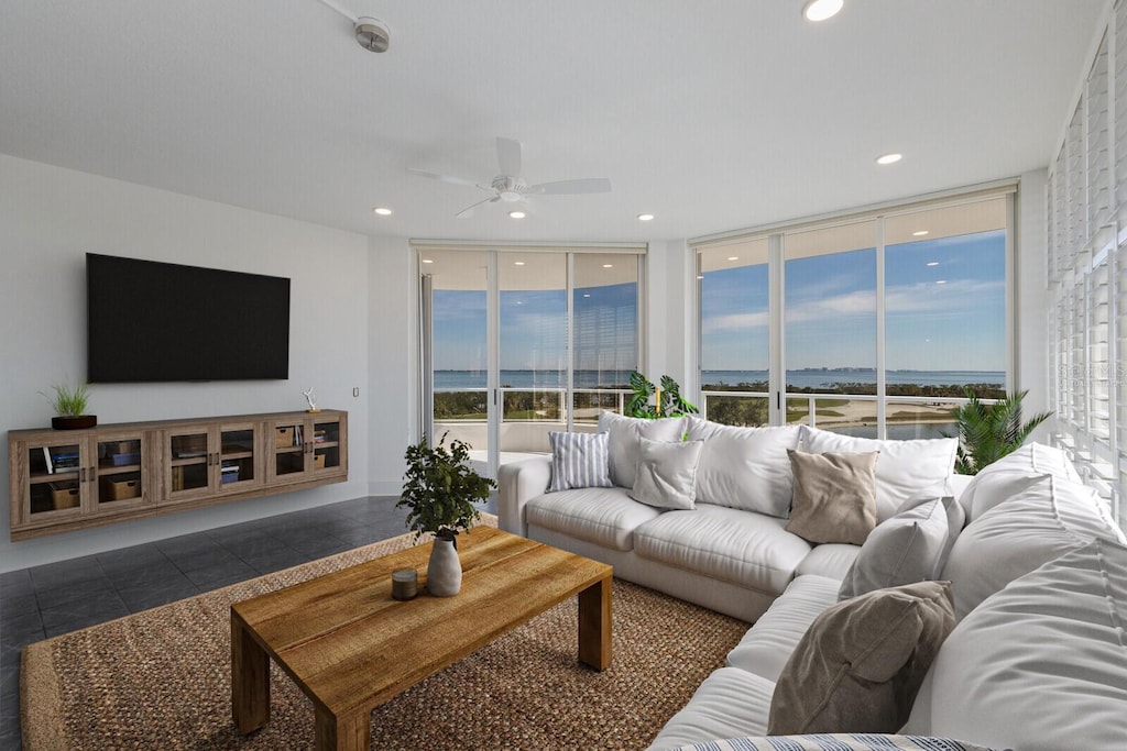 tiled living room featuring ceiling fan