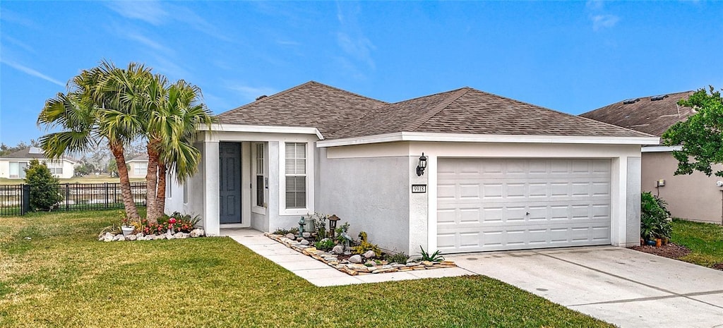 ranch-style home featuring a garage and a front lawn