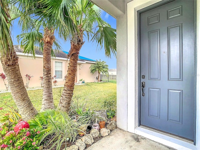 entrance to property featuring a yard