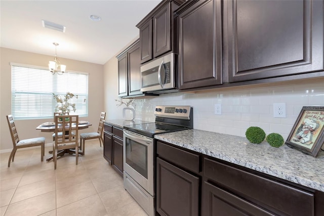 kitchen featuring stainless steel appliances, dark brown cabinets, light tile patterned floors, and backsplash