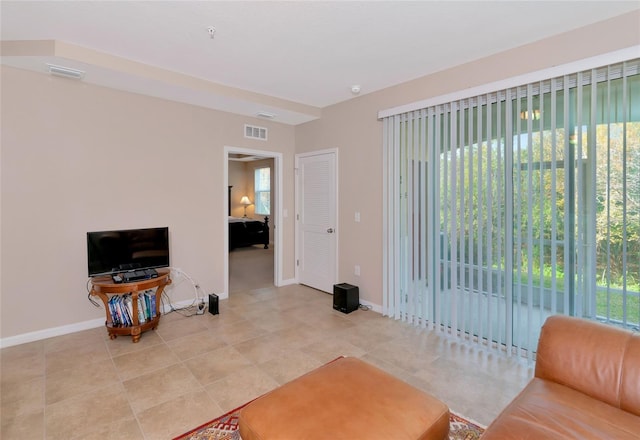 tiled living room featuring a healthy amount of sunlight