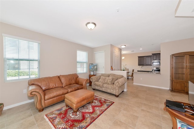 tiled living room featuring a healthy amount of sunlight