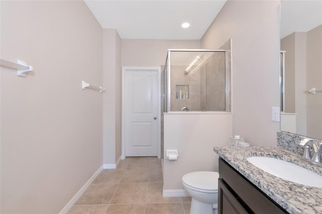 bathroom with vanity, tile patterned floors, toilet, and walk in shower