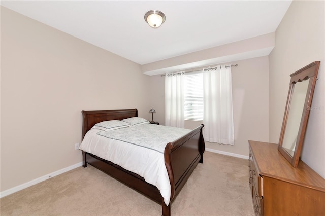 bedroom featuring light colored carpet