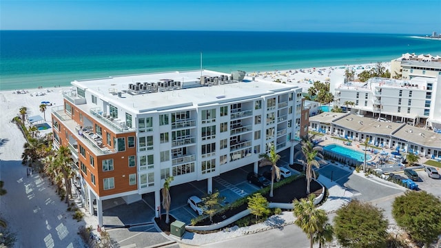 drone / aerial view with a water view and a beach view