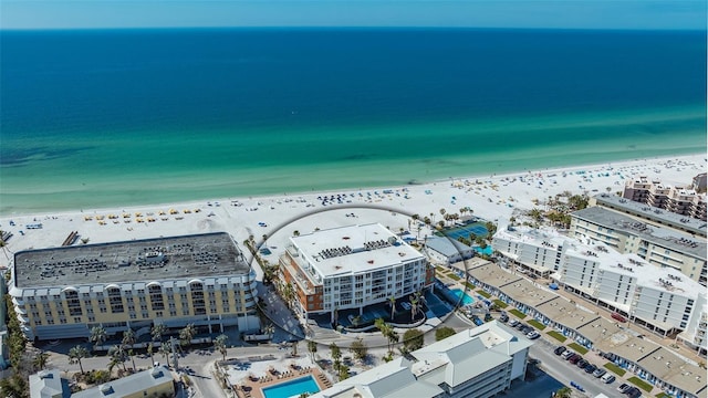 drone / aerial view featuring a water view and a view of the beach