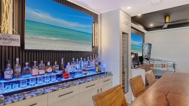 kitchen featuring white cabinetry, stone countertops, and ceiling fan