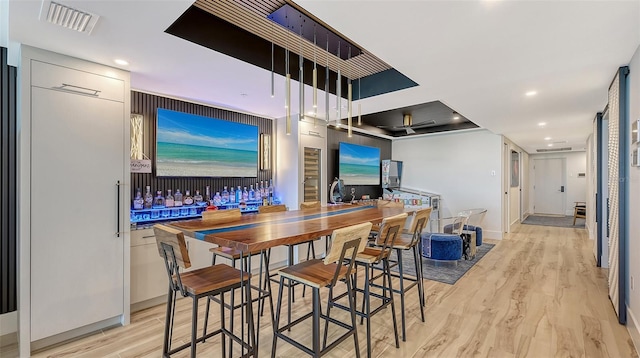 bar with light wood-type flooring