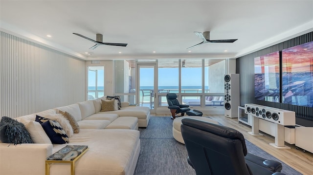 living room featuring ceiling fan, a healthy amount of sunlight, and light hardwood / wood-style floors