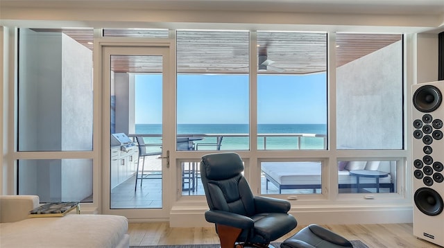 doorway featuring a water view and light hardwood / wood-style floors