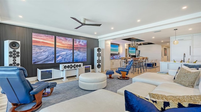 living room with ceiling fan, sink, and light hardwood / wood-style flooring