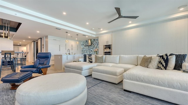 living room featuring sink and ceiling fan