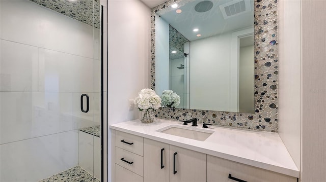 bathroom featuring an enclosed shower and vanity