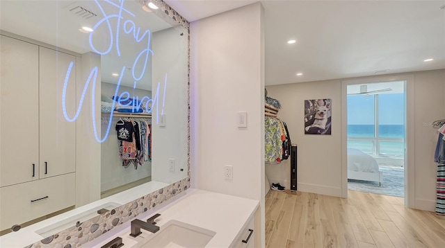 bathroom with vanity and hardwood / wood-style floors