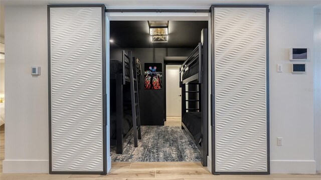 hallway with hardwood / wood-style floors