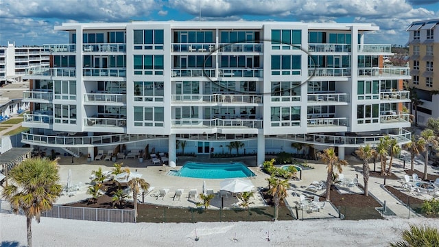 view of building exterior featuring a community pool