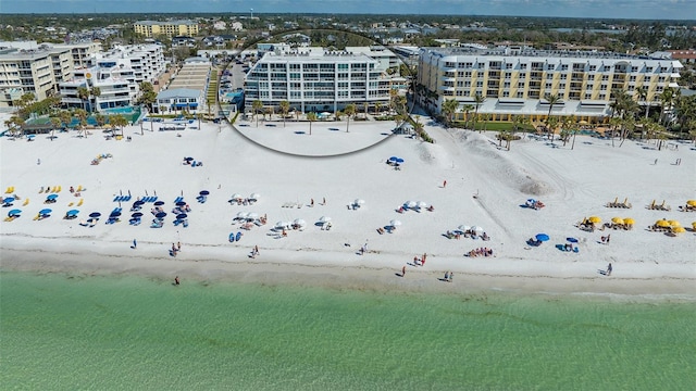 bird's eye view featuring a water view and a beach view