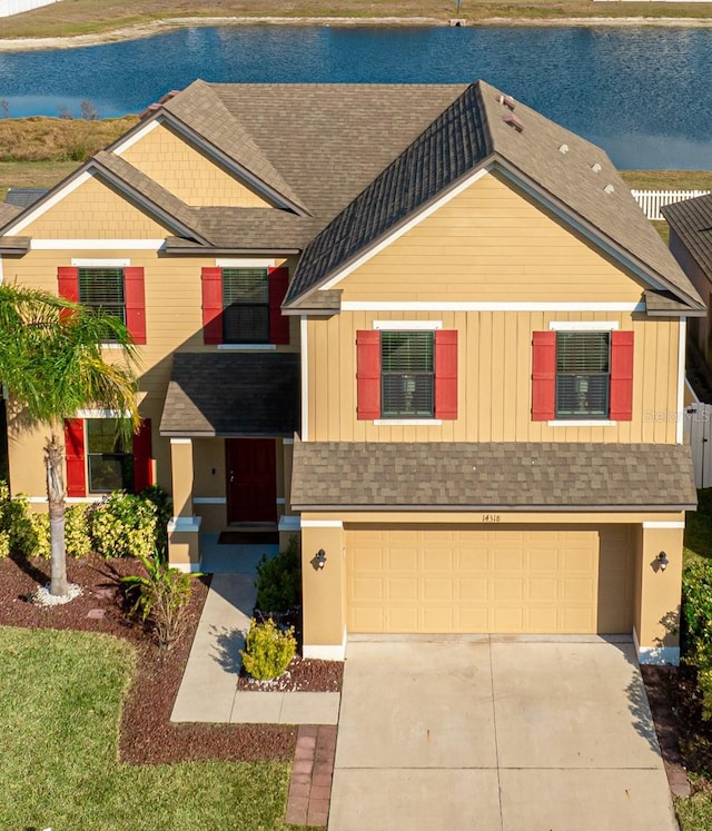 view of front facade with a water view and a garage