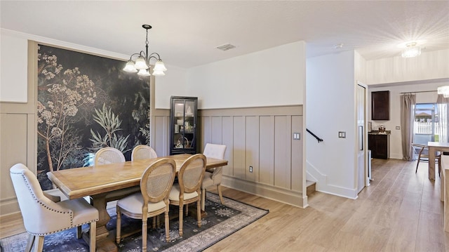 dining room featuring a notable chandelier and light hardwood / wood-style floors