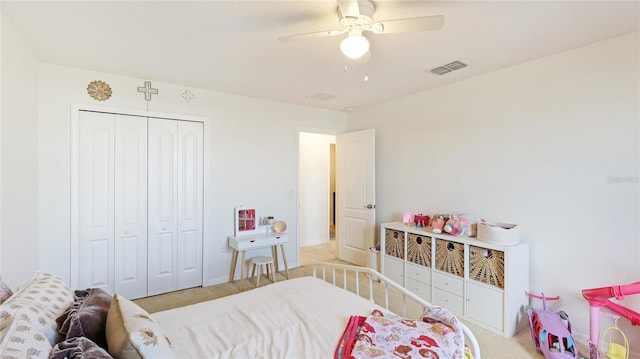 bedroom with ceiling fan, a closet, and light colored carpet