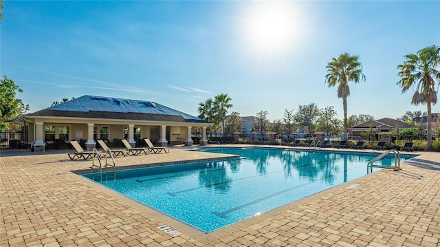 view of pool featuring a patio area and grilling area