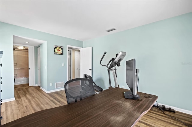 workout area featuring hardwood / wood-style floors