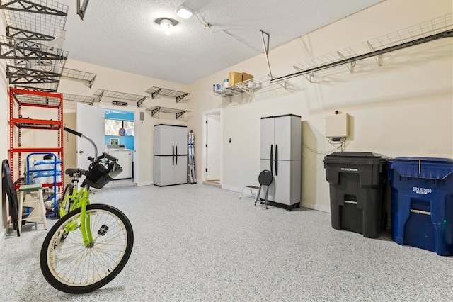 garage featuring white refrigerator and washer / clothes dryer