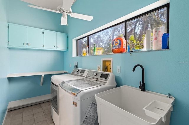 laundry room featuring washer and dryer, sink, cabinets, light tile patterned floors, and a healthy amount of sunlight