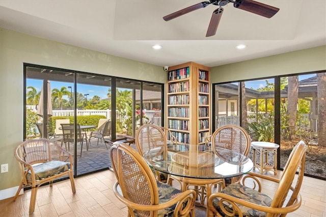 dining space with ceiling fan and light wood-type flooring