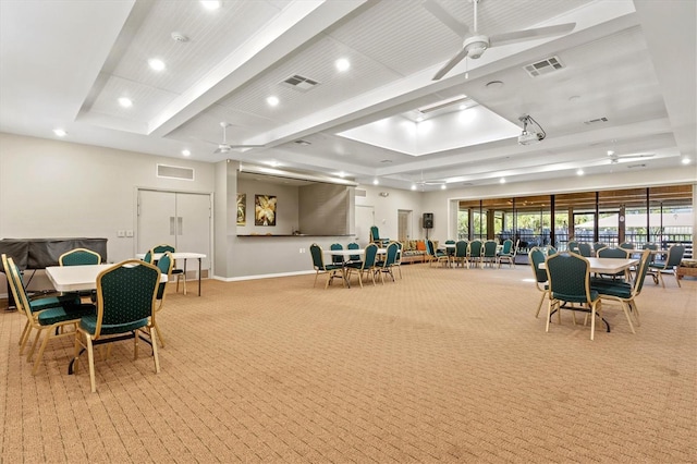 interior space featuring a wealth of natural light, a raised ceiling, and ceiling fan