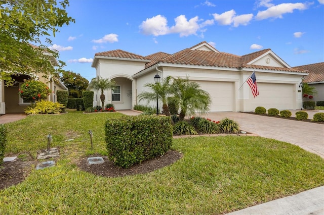 mediterranean / spanish house with a garage and a front yard