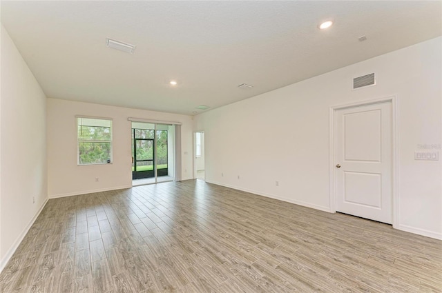 empty room with recessed lighting, visible vents, baseboards, and light wood-style floors