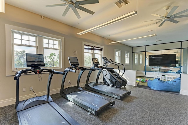 gym featuring a ceiling fan, baseboards, and visible vents