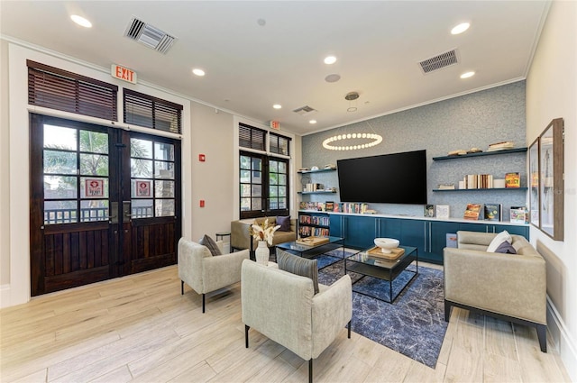 living room featuring visible vents, crown molding, recessed lighting, light wood-style flooring, and french doors