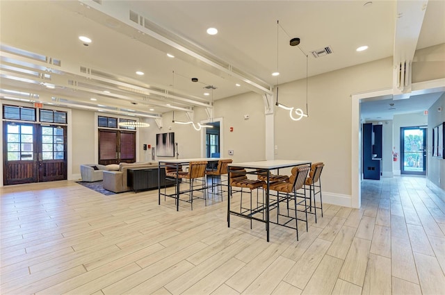 dining area with light wood finished floors, visible vents, recessed lighting, and baseboards